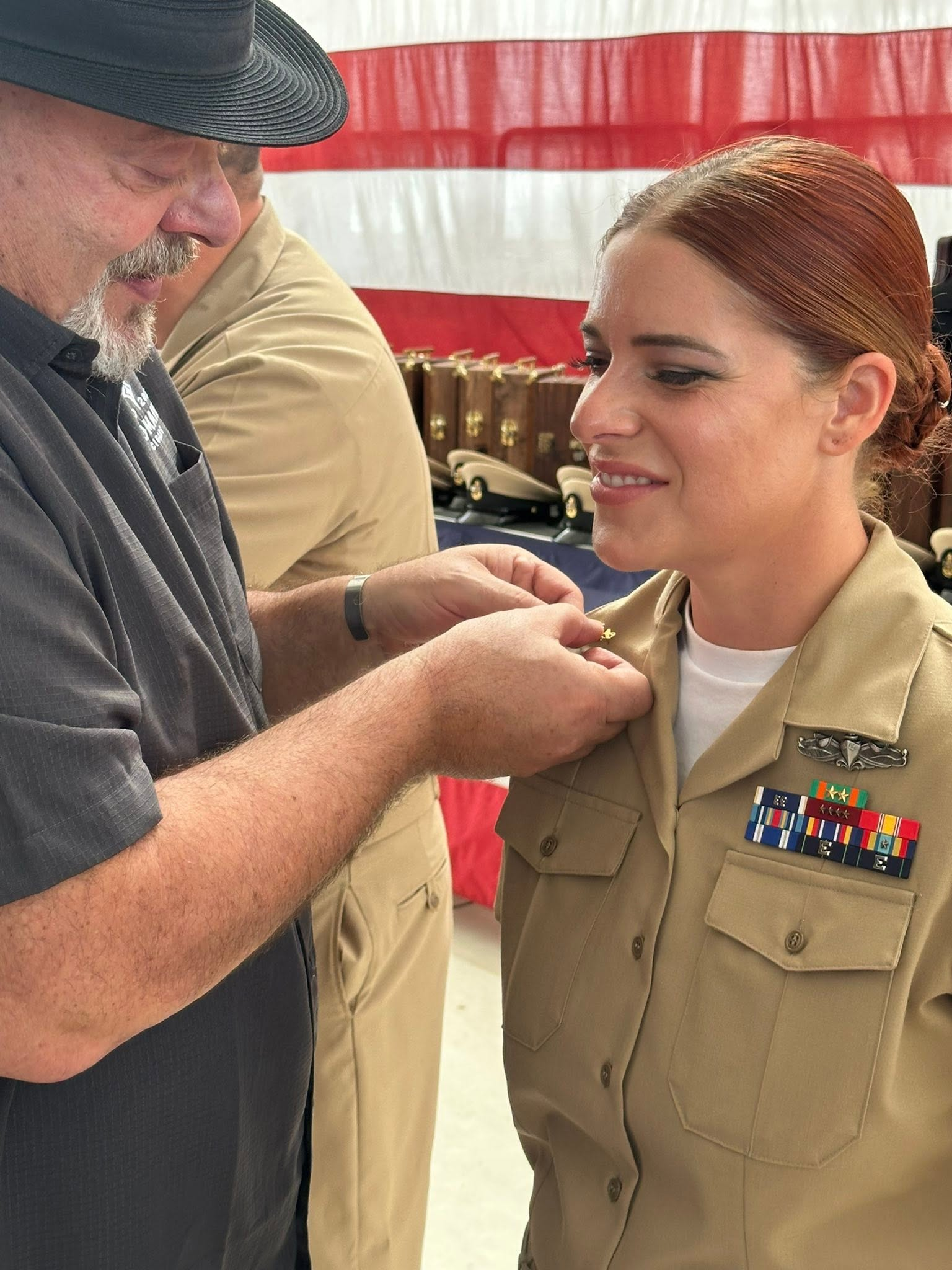 Joseph pinning his daughter's insignia at her U.S. Navy Chief ceremony