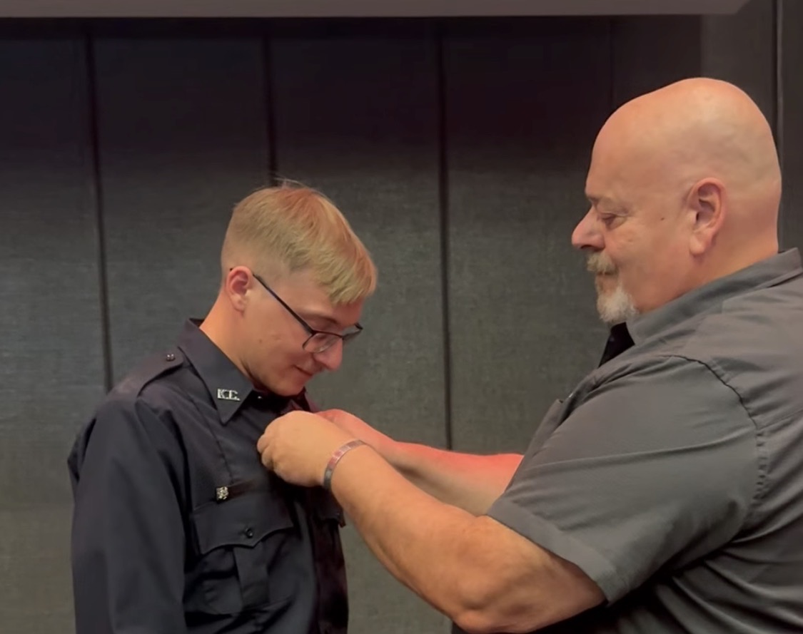 Joseph pinning his son's badge at a KCFD ceremony