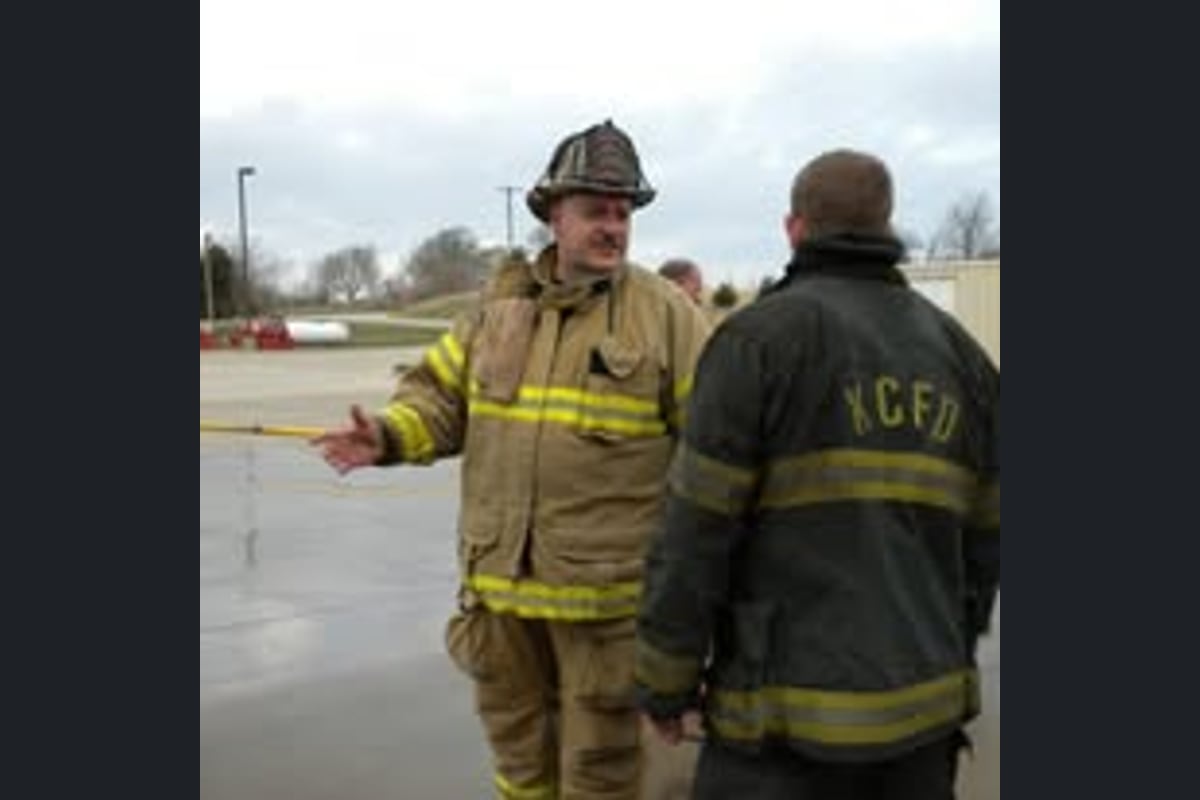 Joseph coaching a firefighter one-on-one during a live training evolution