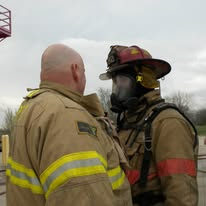 Firefighters running an SCBA evolution under Joseph's instruction